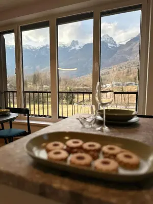a plate of donuts on a table in front of a window at Soca Valley Suites in Bovec