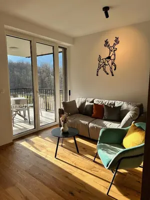 a living room with a couch and a table at Soca Valley Suites in Bovec