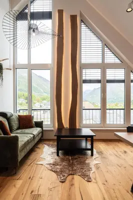 a living room with a couch and a table at Soca Valley Suites in Bovec