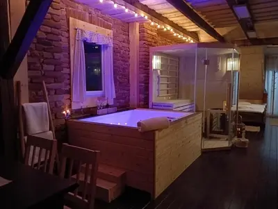 a large bathroom with a tub with purple lighting at Apartmaji Babi in Markovci