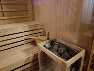 a sauna with a wooden tub with a box in it at Apartmaji Babi in Markovci