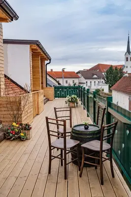 a wooden deck with a table and chairs on a balcony at Apartmaji Babi in Markovci