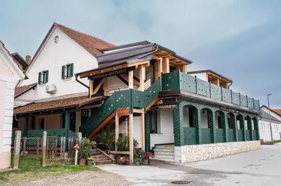 a house with a green and white building at Apartmaji Babi in Markovci