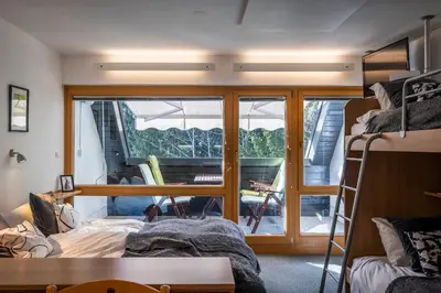 a dorm room with a bunk bed and a balcony at Riversound in Kranjska Gora