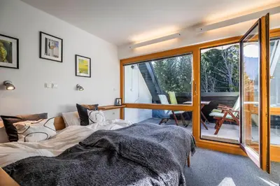 a bedroom with a bed and a sliding glass door at Riversound in Kranjska Gora