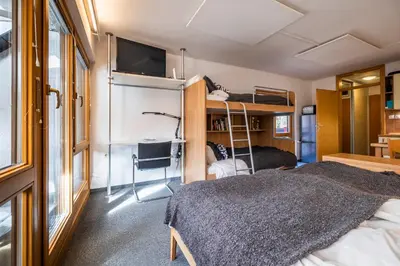 a small room with a bed and bunk beds at Riversound in Kranjska Gora