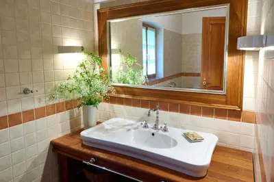 a bathroom with a white sink and a mirror at Four-Bedroom Villa Bajer in Stari Trg pri Ložu