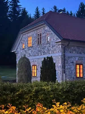 a stone house with orange lights on it at Four-Bedroom Villa Bajer in Stari Trg pri Ložu