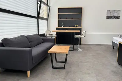 a living room with a couch and a table at Simba Studio Apartment A in Smarjeske Toplice