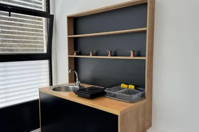 a kitchen counter with a sink and a shelf at Simba Studio Apartment A in Smarjeske Toplice