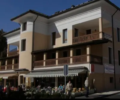 a large building with people walking in front of it at Apartma Popeye in Bovec