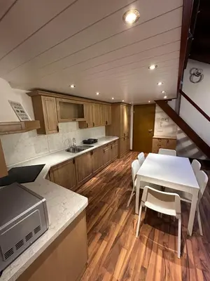 a kitchen with a table and a white table and chairs at Apartma Popeye in Bovec