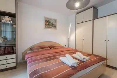 a bedroom with a bed with two towels on it at House Dijana With Pool - Happy Rentals in Nova Vas