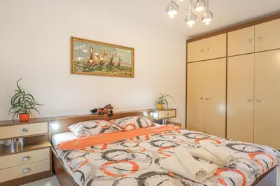 a bedroom with a bed and a painting on the wall at House Dijana With Pool - Happy Rentals in Nova Vas