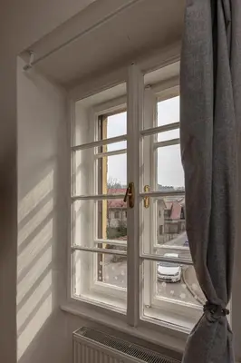 a window in a room with a curtain at Historical Caserne Apartment in Ljubljana