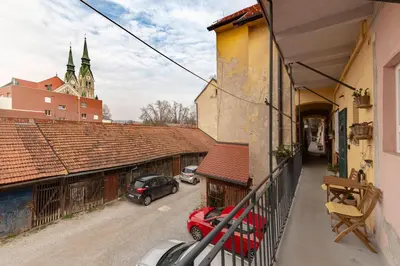 a balcony of a building with a car on a street at Historical Caserne Apartment in Ljubljana