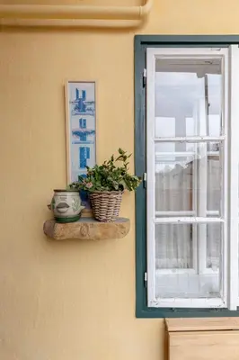 a window with a plant sitting on a shelf next to it at Historical Caserne Apartment in Ljubljana
