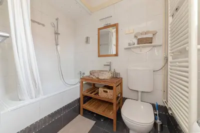 a bathroom with a toilet and a shower and a sink at Historical Caserne Apartment in Ljubljana