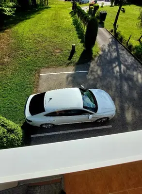 a car parked on a street in a park at Apartma Jurka in Podčetrtek
