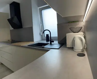 a small kitchen with a sink and a window at Homestead - Domačija - Nabergoj in Podnanos