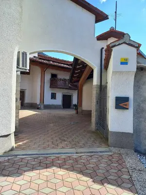 an archway in a building with a brick courtyard at Homestead - Domačija - Nabergoj in Podnanos