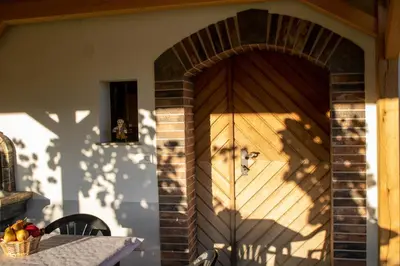 a wooden door with a basket of fruit on a table at Zidanica Vidrih in Dolenjske Toplice