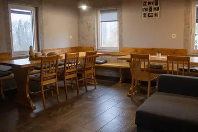 a dining room with wooden tables and chairs at Zidanica Vidrih in Dolenjske Toplice