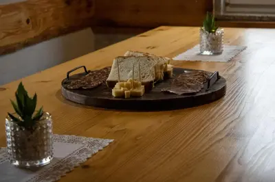 a table with a plate of food on a table at Zidanica Vidrih in Dolenjske Toplice