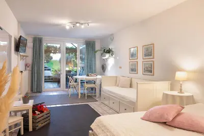 a bedroom with a bed and a desk and a table at Apartments Ladka in Begunje na Gorenjskem