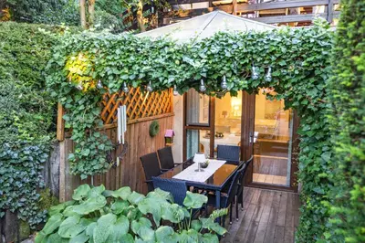 an outdoor patio with a table and chairs and plants at Apartments Ladka in Begunje na Gorenjskem