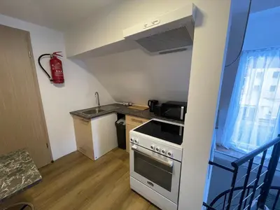 a small kitchen with a stove and a sink at Apartma Tonii in Bovec