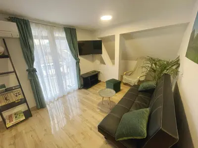 a living room with a couch and a chair at Apartma Tonii in Bovec