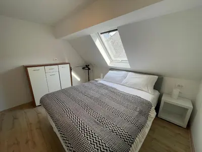 a small bedroom with a bed and a window at Apartma Tonii in Bovec