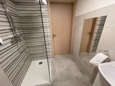 a bathroom with a shower and a sink at Apartma Tonii in Bovec