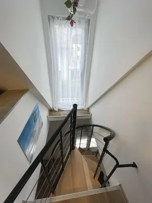 a spiral staircase with a window in a house at Apartma Tonii in Bovec