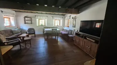 a living room with a couch and a tv at MaLu vintage house with garden in Logatec