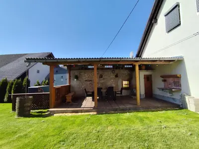 a patio with a roof on a house at MaLu vintage house with garden in Logatec