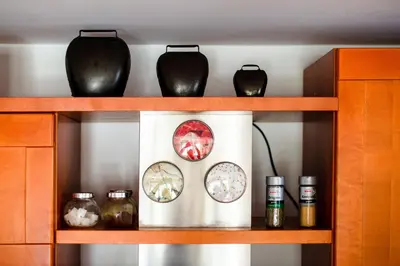 a shelf with plates and vases on it at Apartma Pokljuška idila - Idyllic Pokljuka Studio above Bled in Bled
