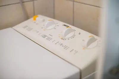 a white washing machine with dials on top of it at Apartma Pokljuška idila - Idyllic Pokljuka Studio above Bled in Bled