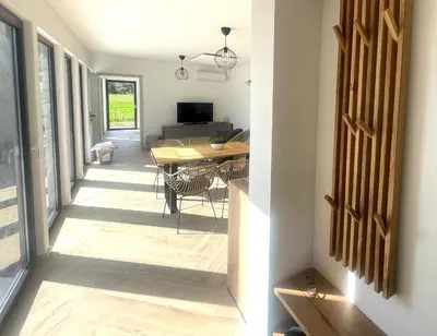 a hallway of a house with a table and chairs at Luxury Holiday House BREZOV BREG in Dankovci