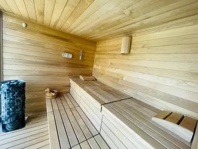 a large wooden sauna with a bench in it at Luxury Holiday House BREZOV BREG in Dankovci