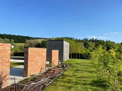 a garden with a brick building in the middle at Luxury Holiday House BREZOV BREG in Dankovci
