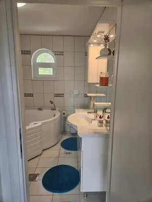 a bathroom with a tub and a sink and a bath tub at House Tereza near Olimje, Podčetrtek in Pristava pri Mestinju