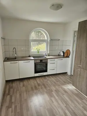 a kitchen with white cabinets and a sink and a window at House Tereza near Olimje, Podčetrtek in Pristava pri Mestinju