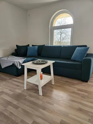 a living room with a blue couch and a table at House Tereza near Olimje, Podčetrtek in Pristava pri Mestinju