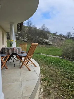 a patio with a table and chairs on a porch at House Tereza near Olimje, Podčetrtek in Pristava pri Mestinju