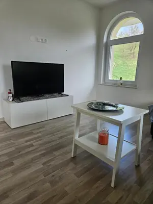 a living room with a tv and a table at House Tereza near Olimje, Podčetrtek in Pristava pri Mestinju