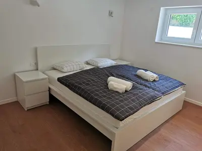 a bedroom with a bed with two pillows on it at Naia Apartments in Novo Mesto