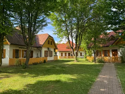 a row of houses with trees in the yard at APARTMA MORAVSKE TOPLICE in Moravske Toplice