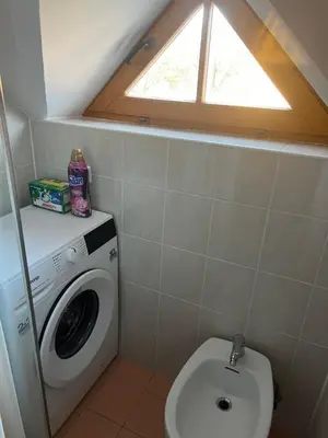 a bathroom with a washing machine and a window at APARTMA MORAVSKE TOPLICE in Moravske Toplice